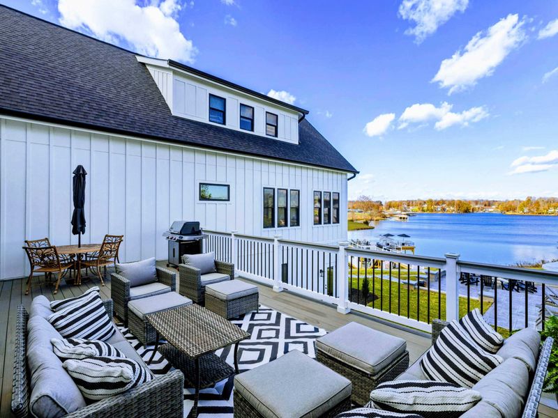 Backyard - Upper deck dining area with outdoor seating and treetop views.