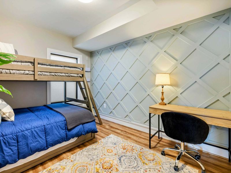 Bunk Room (Small) - View from the desk area showing the bunks and wall decor.