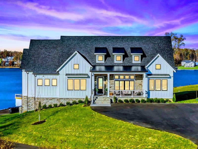 Exterior - Final wide shot of the modern farmhouse from the lakefront.