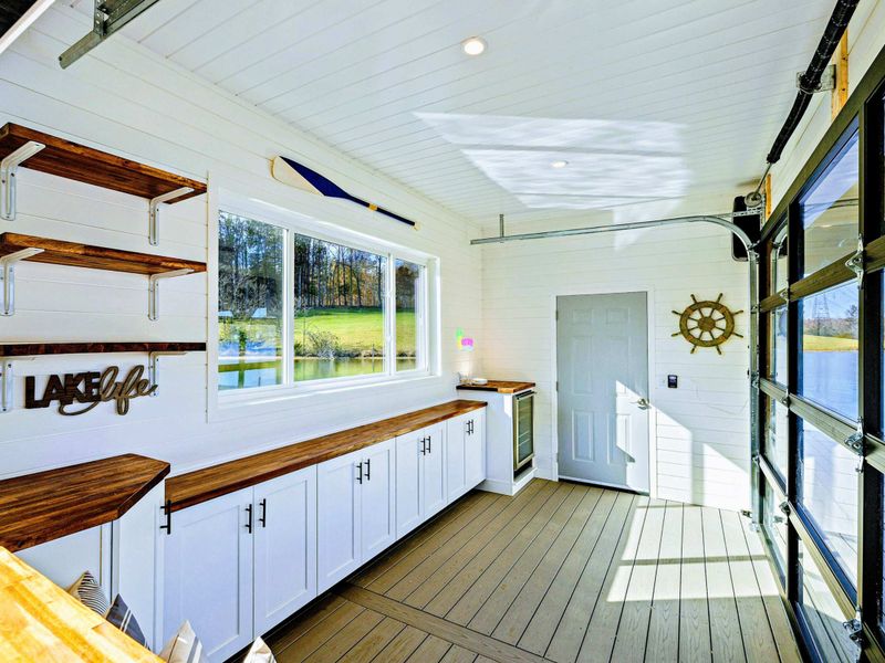 Boathouse - Lake-themed interior with counter space, nautical decor, and large windows.
