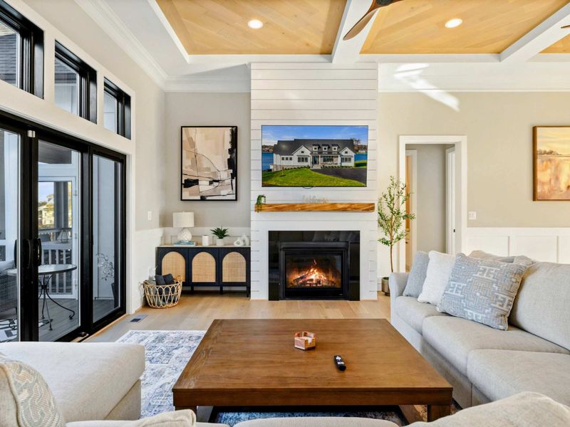 Great Room - Alternate angle of the living room with fireplace and natural light.