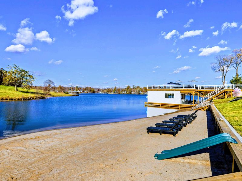 Beach - Lounge chairs, a slide, and dock access from the sandy beach.