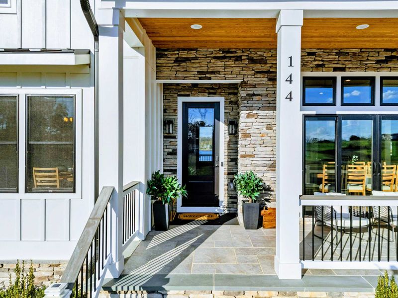 Exterior - Front door with stone surround and a glimpse of the lake through the entry.