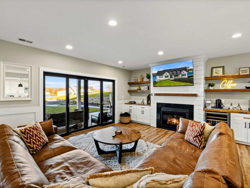 Lower Living Area - Leather sectional, stone fireplace, and sliding doors to the patio.