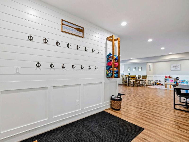 Exterior - Mudroom with nautical hooks, shoe storage, and a clean modern finish.