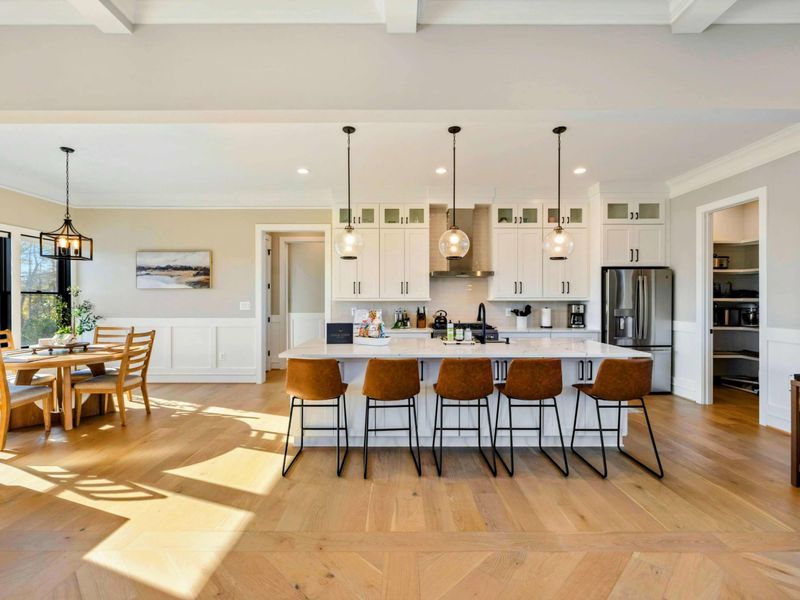 Kitchen - Professional-grade range, walk-in pantry, and marble countertops.