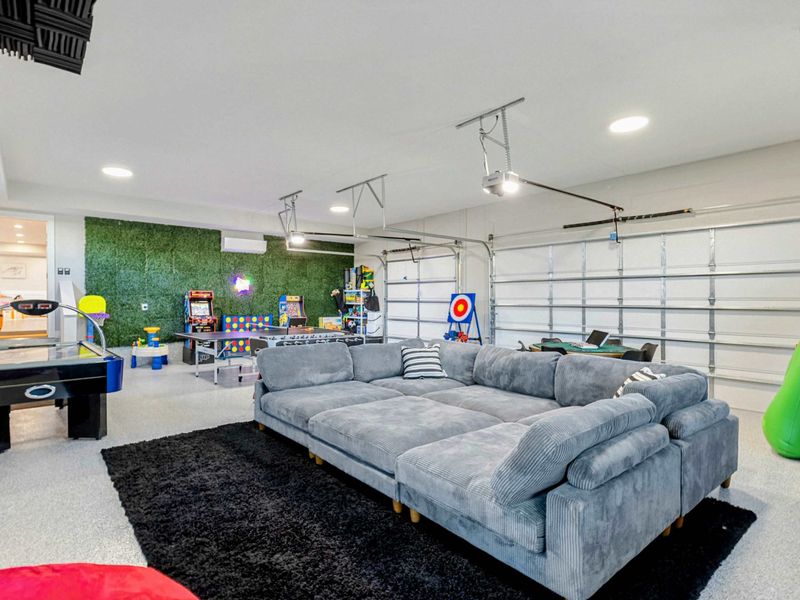 Game Room - Overhead view of the poker table with neon signage in the background.