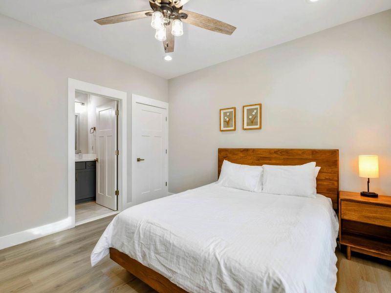 Cozy bedroom with a comfortable bed, modern furnishings, and an en suite bathroom for added privacy and convenience.