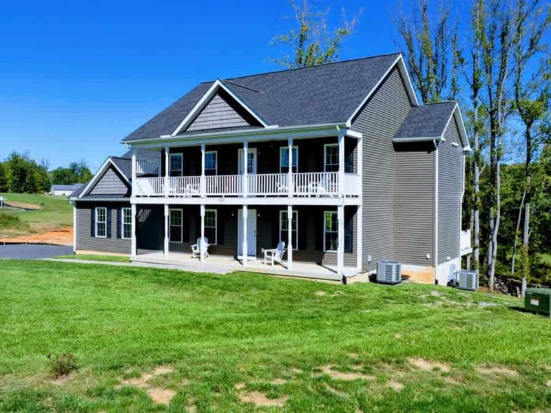 House at Day - With balconies and lake beyond.