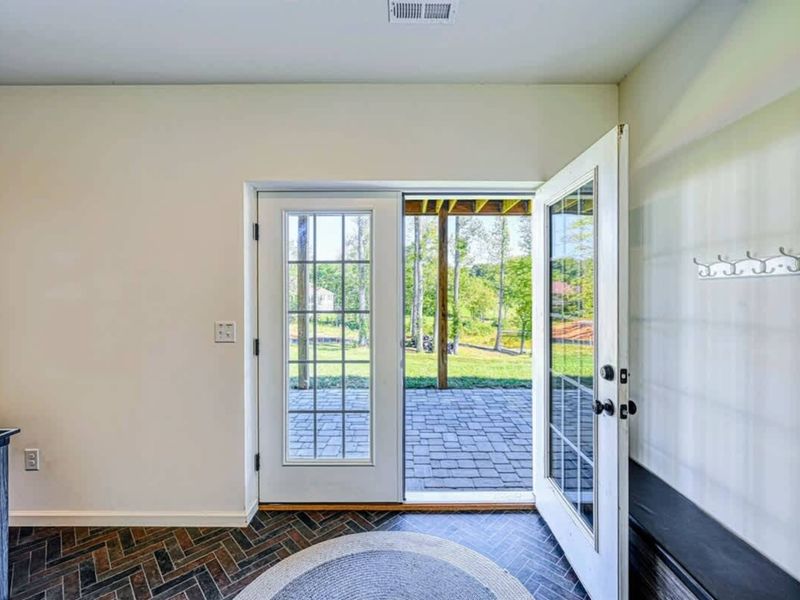 Front Entry - French doors open to the patio, first lake views from the moment you walk in.