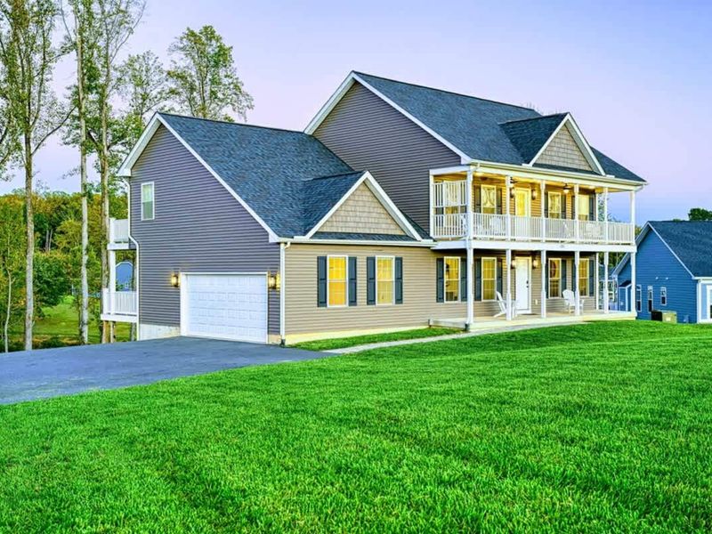 Front of Home - Two stories, multiple balconies, the lake side of the house facing the water.