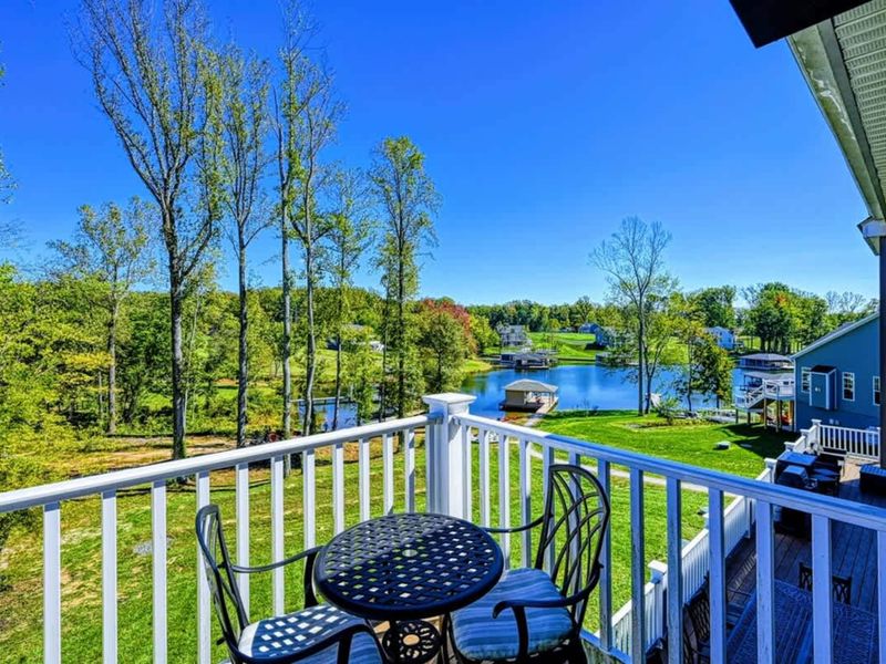Primary Balcony - A bistro set, the lake in front, the quietest cup of coffee in the house.