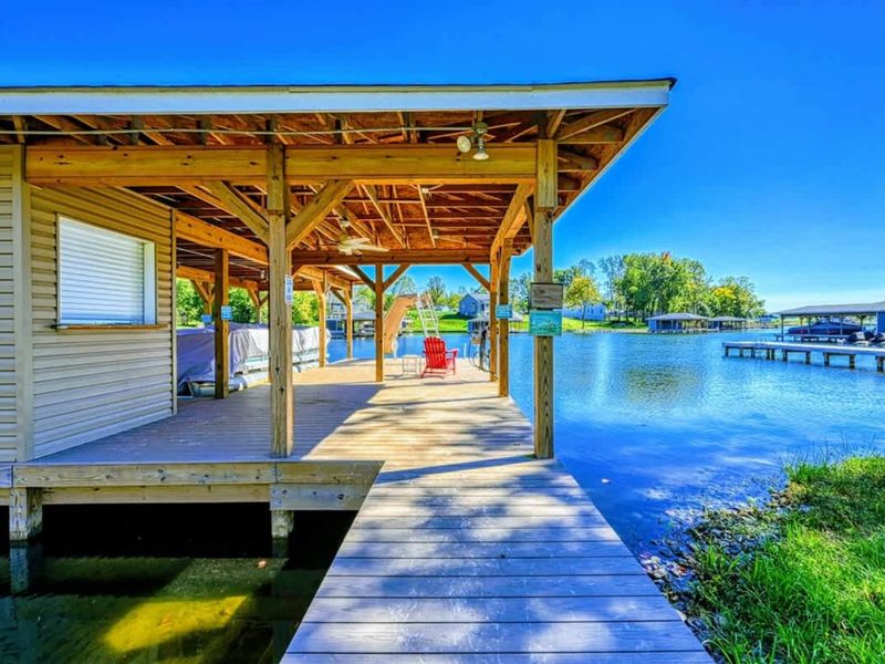 Dock - The morning ritual: coffee in hand, bare feet on the planks, the lake still and gold.