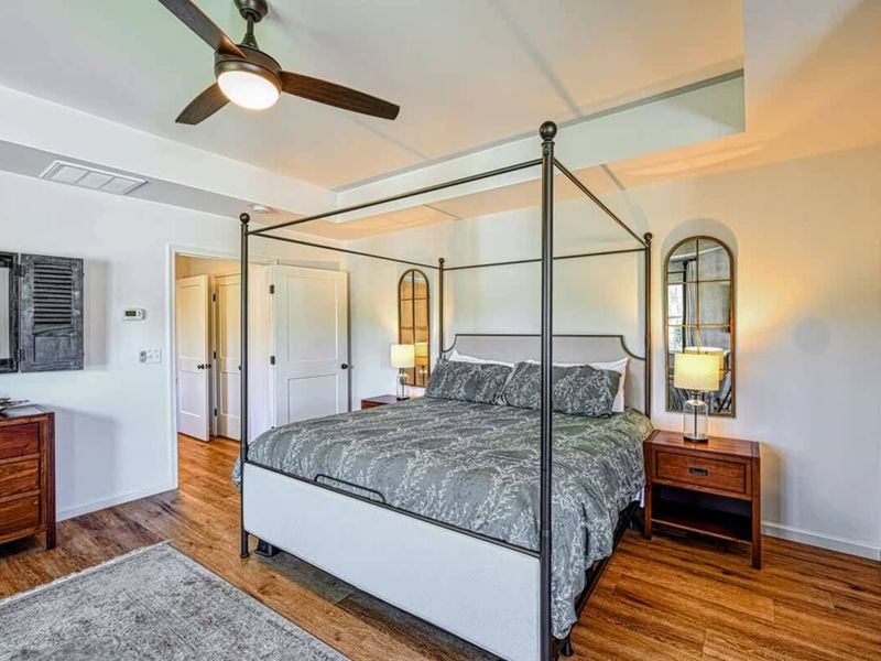 Primary Suite - Four-poster king, ensuite bath, and your own private balcony for morning quiet.