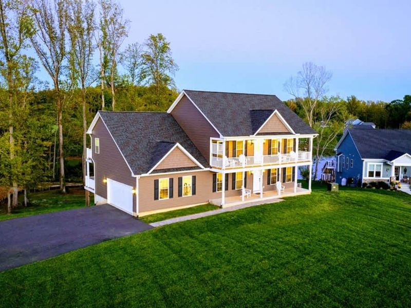 Front Approach - First impression: an estate-scale lake home on the quiet private side.