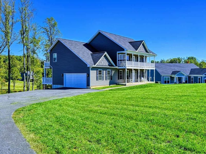Curb View - From the road: a private lake retreat, well set back.