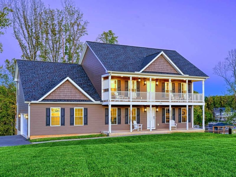 Side of Home - Spacious driveway, lush lawn, easy access from the road.