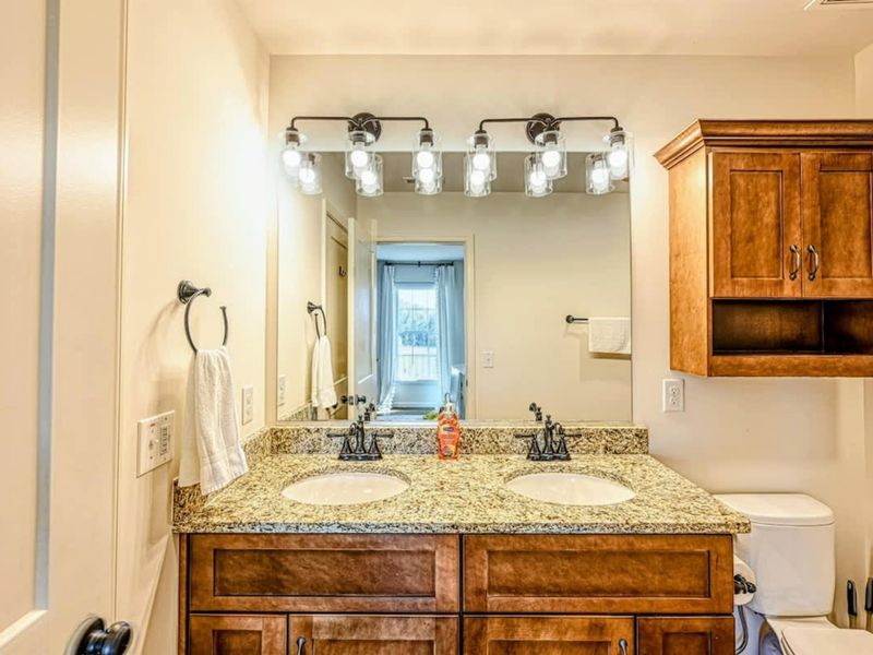 Suite #3 Bath - Dual sinks, shower-tub combination, finished for shared family use.
