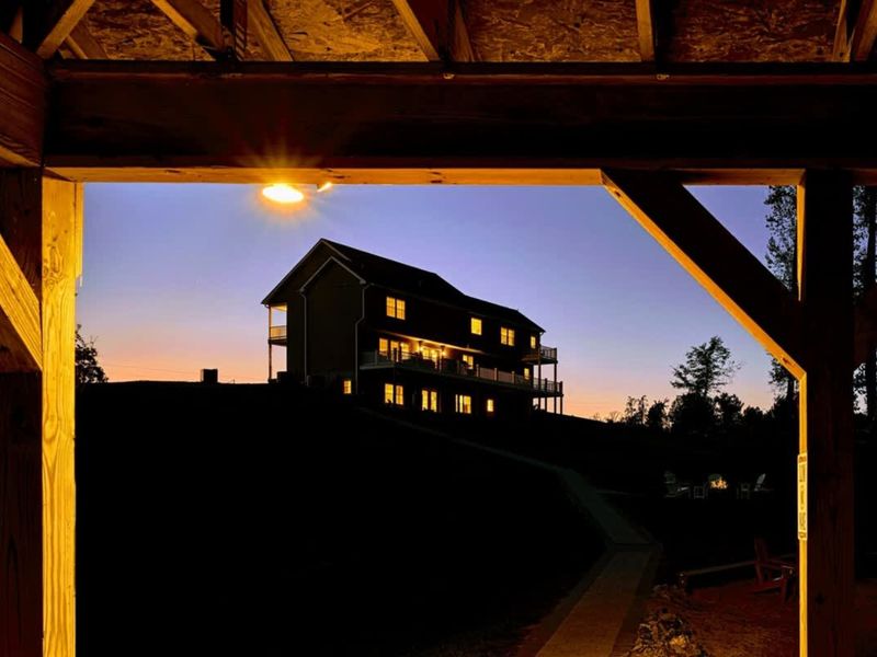 Sunset Through the Dock - Warm light cutting through the boathouse beams.
