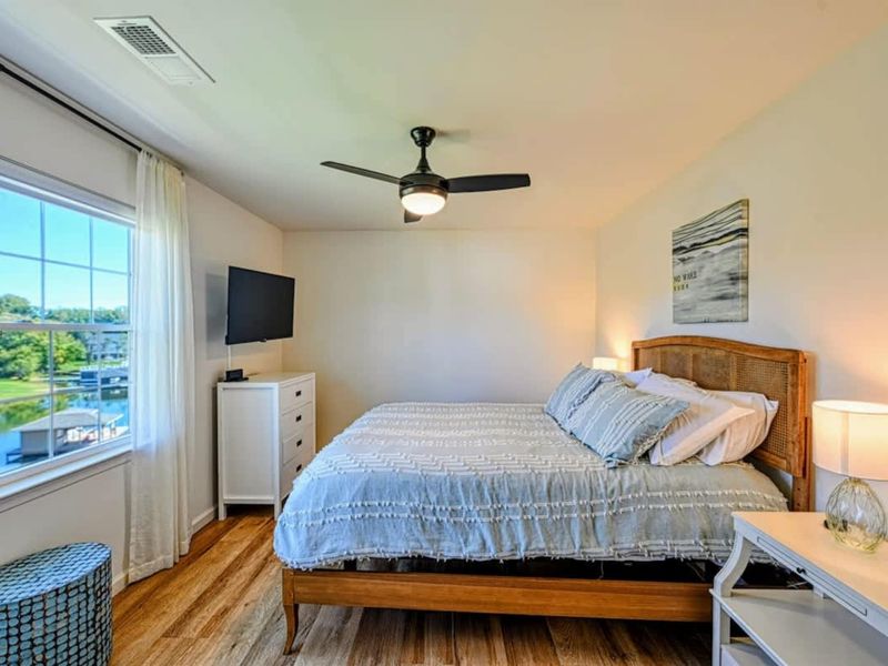 Suite #2 - King bed, ensuite bath, ceiling fan, a window framing the lake.