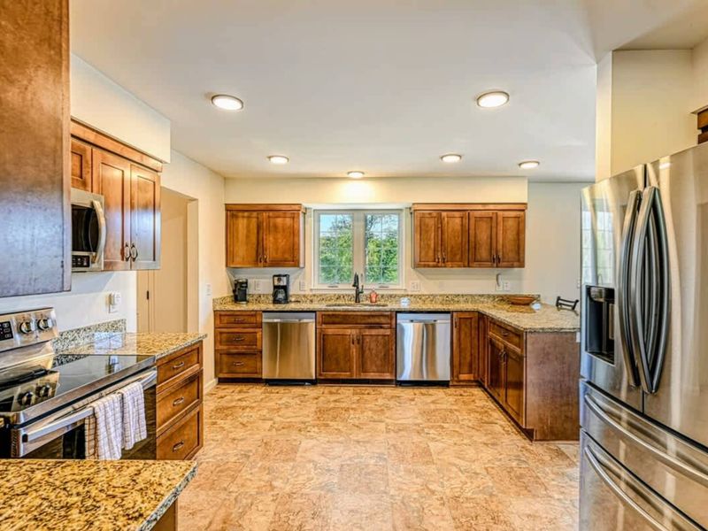 Chef's Kitchen - Granite, full-size appliances, and two dishwashers because a sixteen-guest weekend needs them.