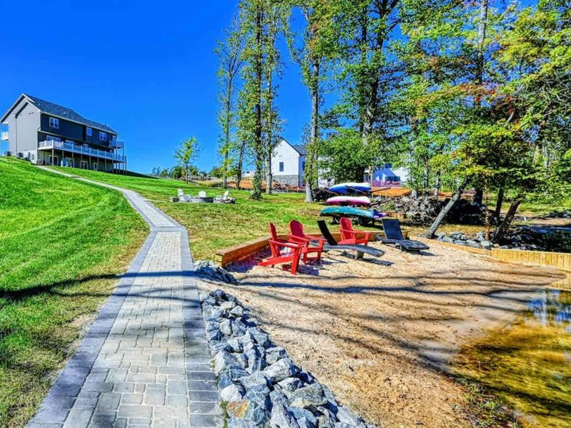 Path to the Dock - Kayaks and Adirondack chairs at the end of the path. Take your pick.