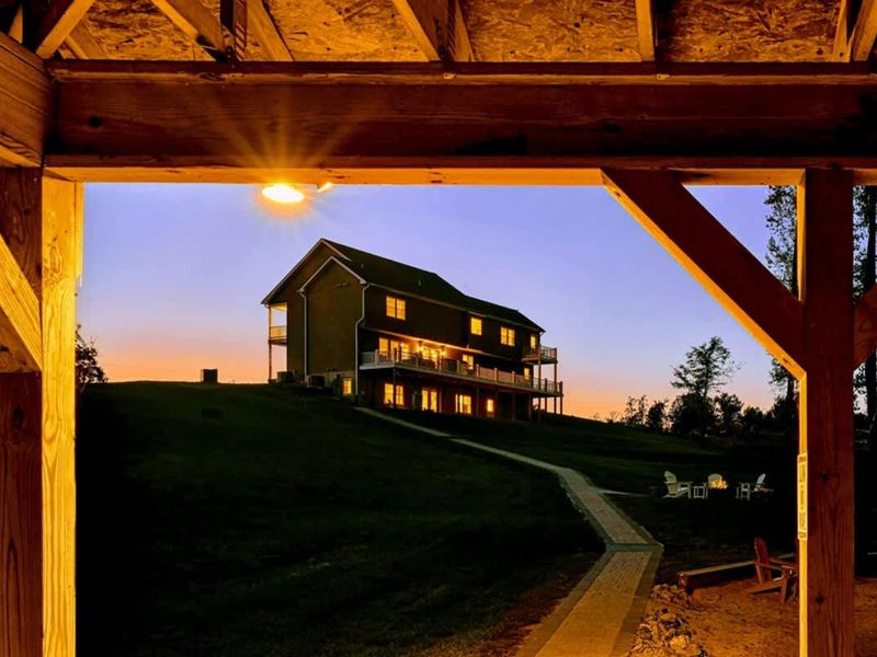 Sunset Through the Dock - The house framed at golden hour, exactly the way the name promises.