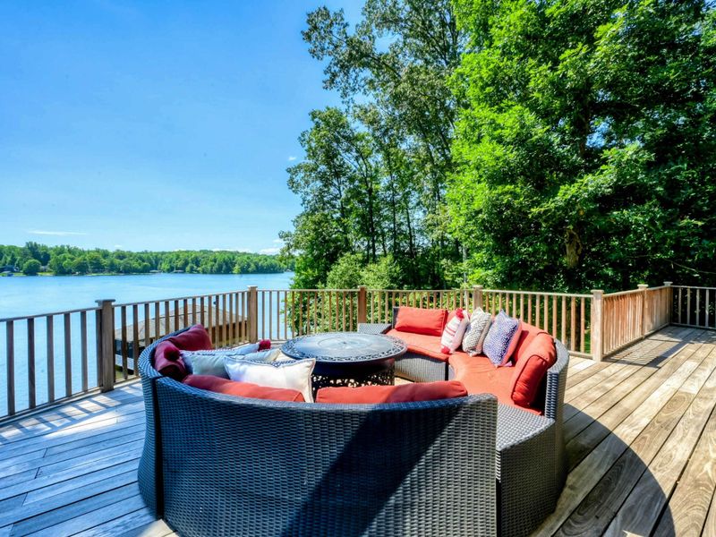 A spacious lakeside deck offers comfortable seating with breathtaking water views, perfect for relaxation and enjoying nature.