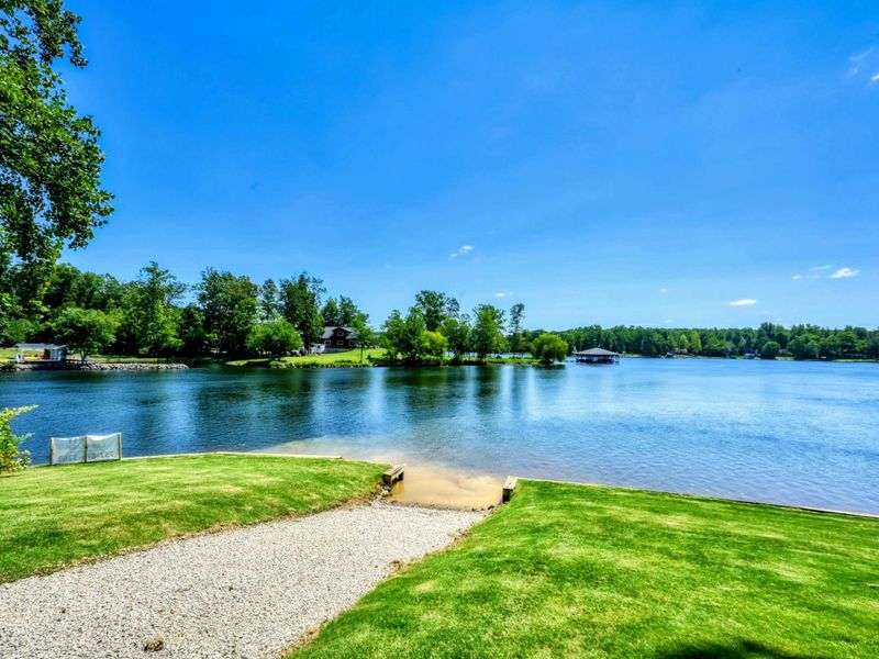 Private boat ramp with lush surroundings offers easy water access for boats, jet skis, and kayaks, perfect for a seamless Lake Anna adventure.