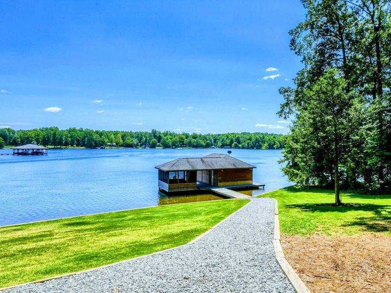 Beautiful lakefront boathouse with a covered dock and panoramic water views.