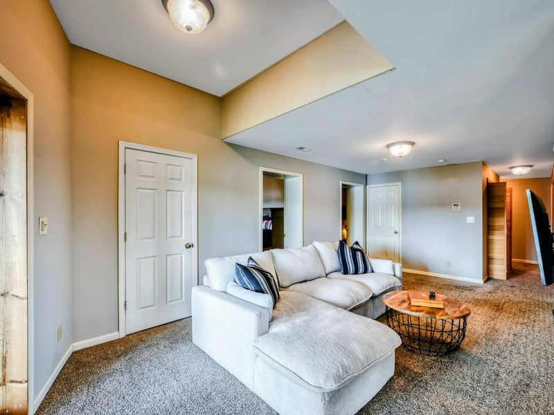 The spacious room offers a comfortable sectional sofa and easy access to adjacent spaces.