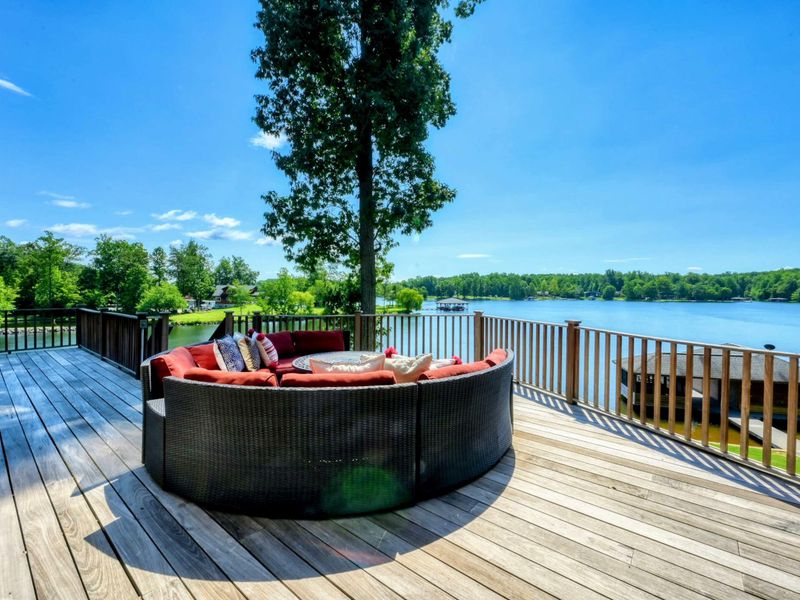 A spacious lakeside deck offers comfortable seating with breathtaking water views, perfect for relaxation and enjoying nature.