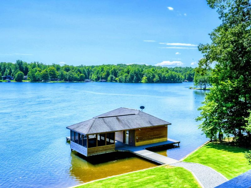 Beautiful lakefront boathouse with a covered dock and panoramic water views.