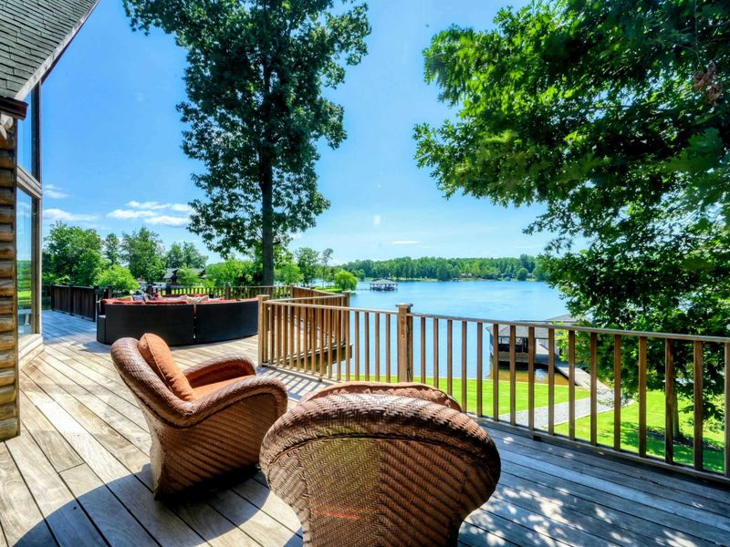 A spacious lakeside deck offers comfortable seating with breathtaking water views, perfect for relaxation and enjoying nature.