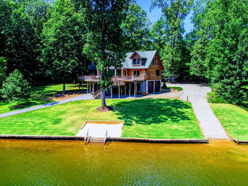 Stunning waterfront retreat with a private dock and serene wooded surroundings.