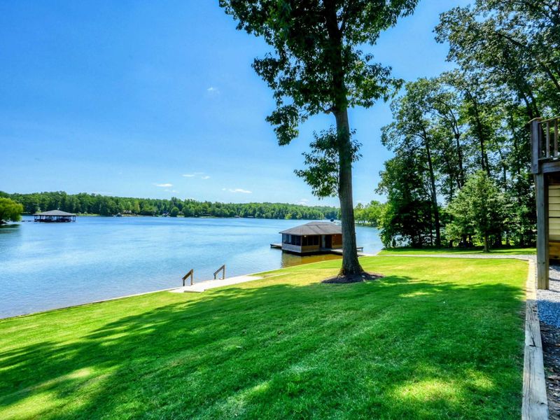 Beautiful lakefront boathouse with a covered dock and panoramic water views.