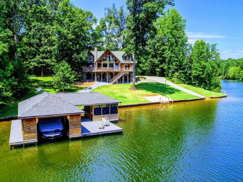 Stunning waterfront retreat with a private dock and serene wooded surroundings.