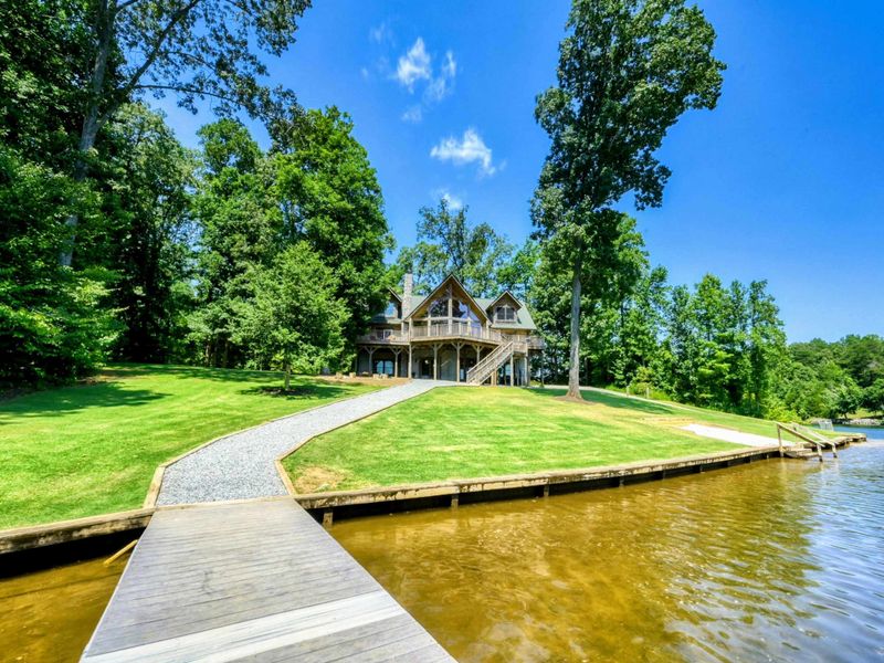 Stunning waterfront retreat with a private dock and serene wooded surroundings.