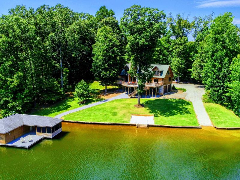 Stunning waterfront retreat with a private dock and serene wooded surroundings.