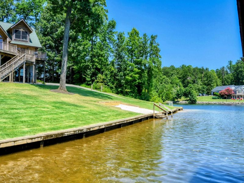 Stunning waterfront retreat with a private dock and serene wooded surroundings.
