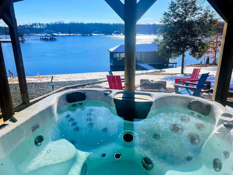 Enjoy ultimate relaxation in our hot tub with stunning lake views, perfect for unwinding year-round.