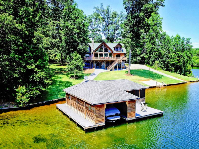 Stunning waterfront retreat with a private dock and serene wooded surroundings.