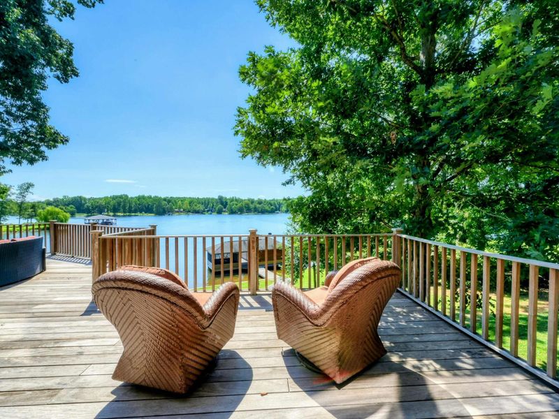 A spacious lakeside deck offers comfortable seating with breathtaking water views, perfect for relaxation and enjoying nature.