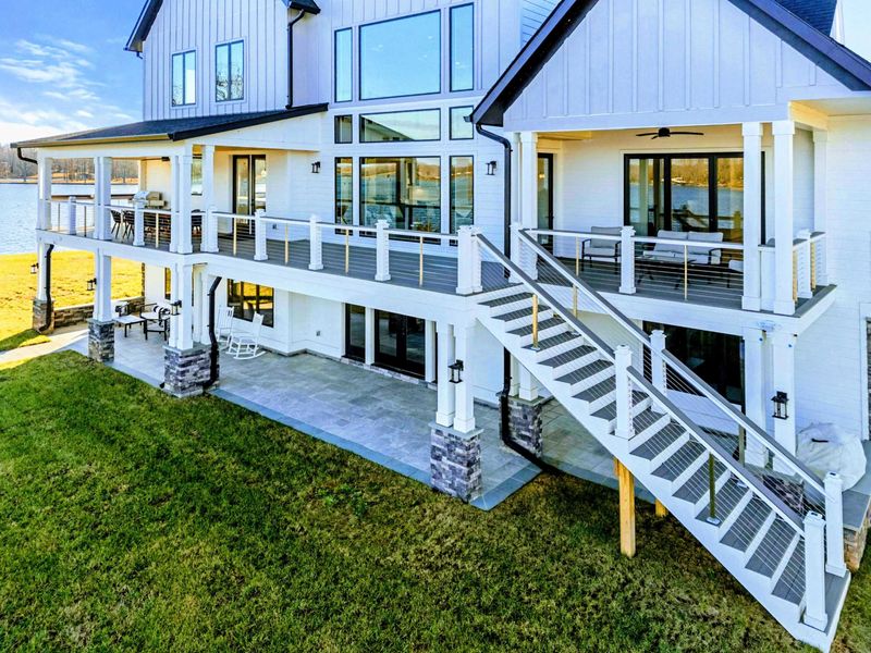 A stunning waterfront property features a spacious home with a private dock and panoramic views of the lake, perfect for relaxation and outdoor enjoyment.