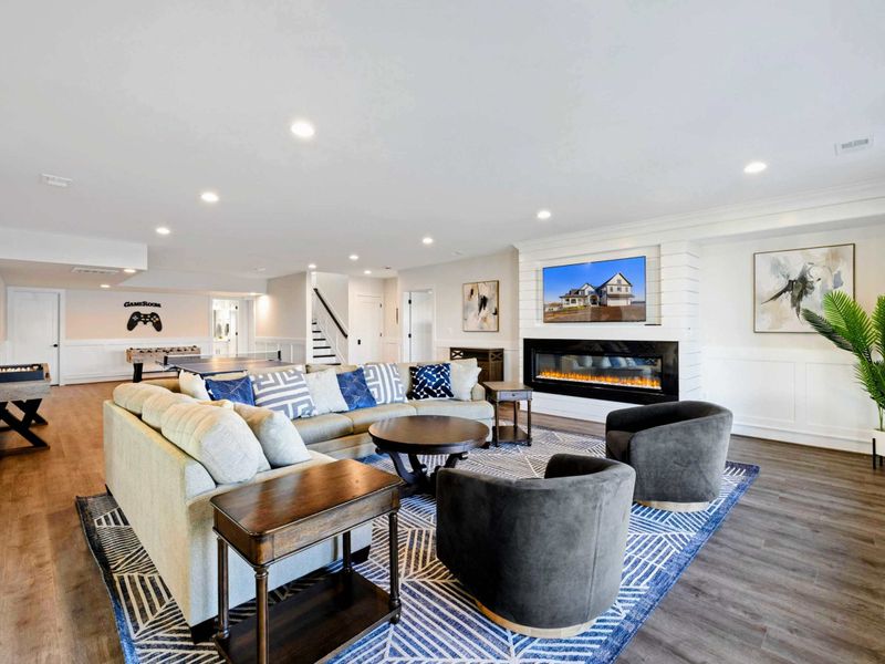 Lower Lounge - Open family room with sectional, fireplace, and game tables a few steps away. The lake just outside the doors.