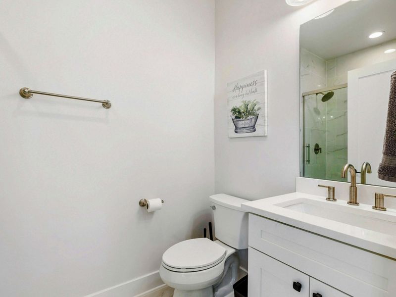Half Bath - Single vanity with brushed-brass fixtures, just off the upper-level bedrooms.