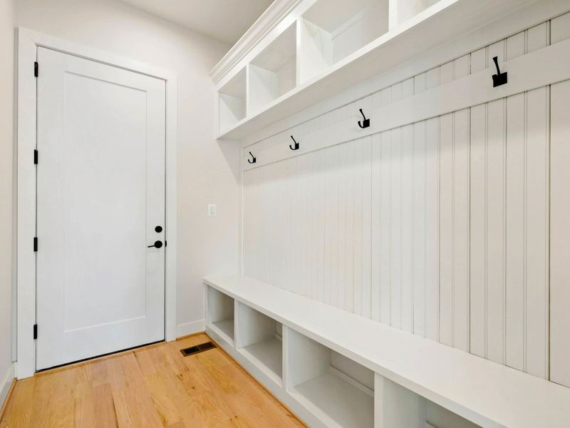 Mudroom - Bench seating, hooks, and cubbies right by the side entrance for easy come-and-go after a day on the water.