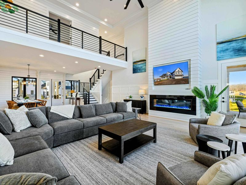 Great Room - Soaring ceilings, a long electric fireplace, the dock and lake out the back wall. Open to the kitchen and dining for easy flow.