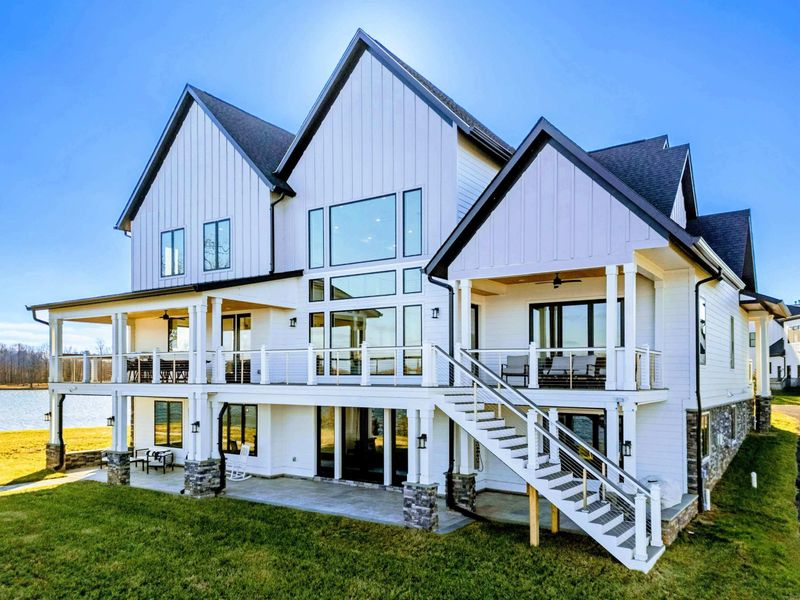 A stunning waterfront property features a spacious home with a private dock and panoramic views of the lake, perfect for relaxation and outdoor enjoyment.