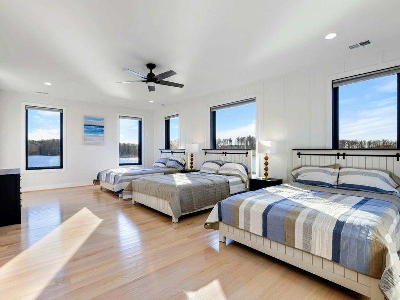 Suite - Three more beds with striped quilts, lake views, and natural light most of the day.